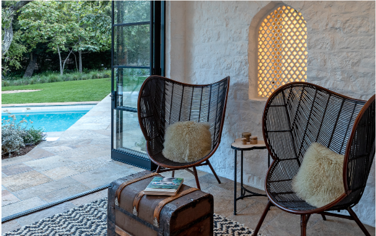 sitting area with open doors overlooking pool